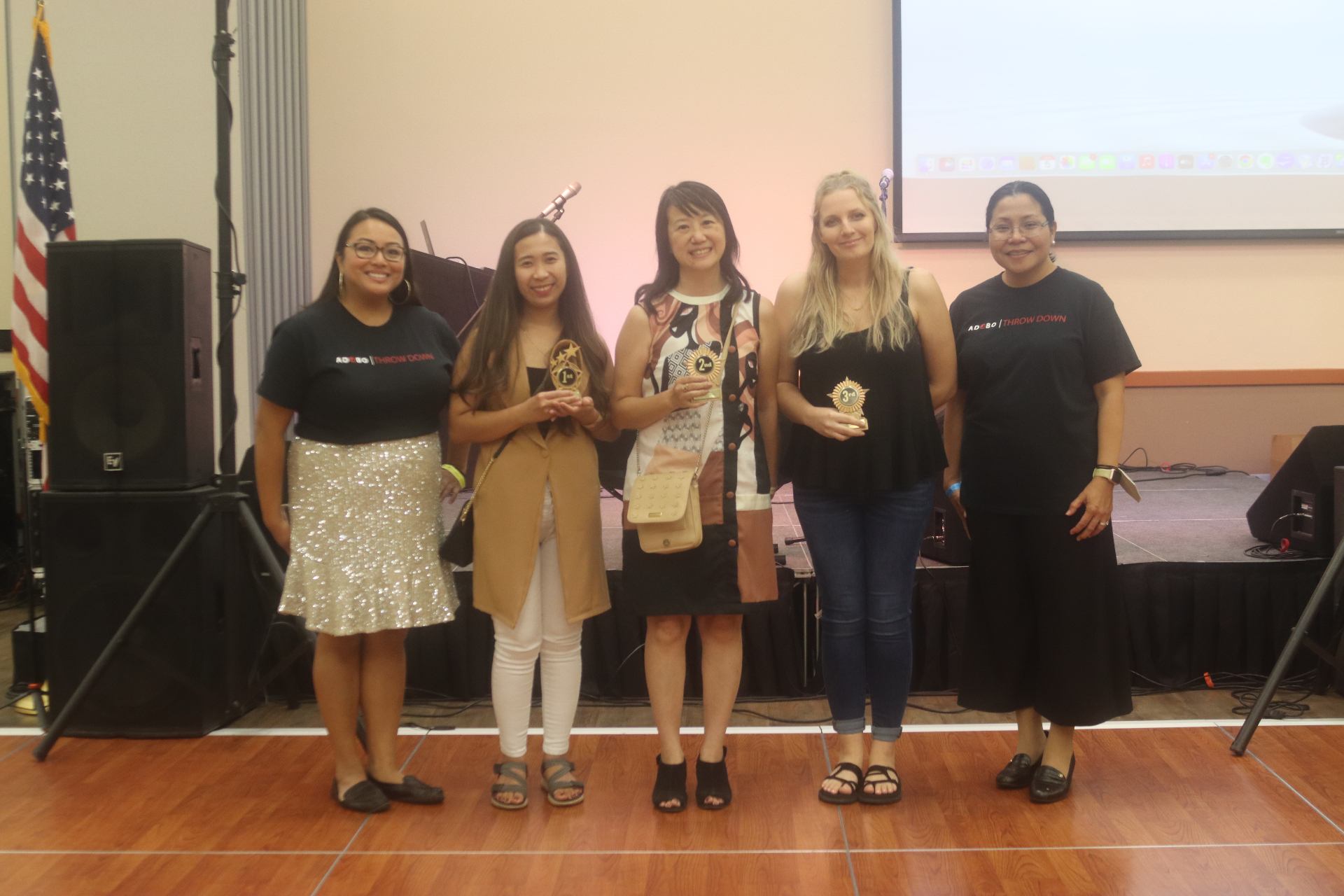 Ube Throwdown competitors and organizers celebrating on stage with trophies.